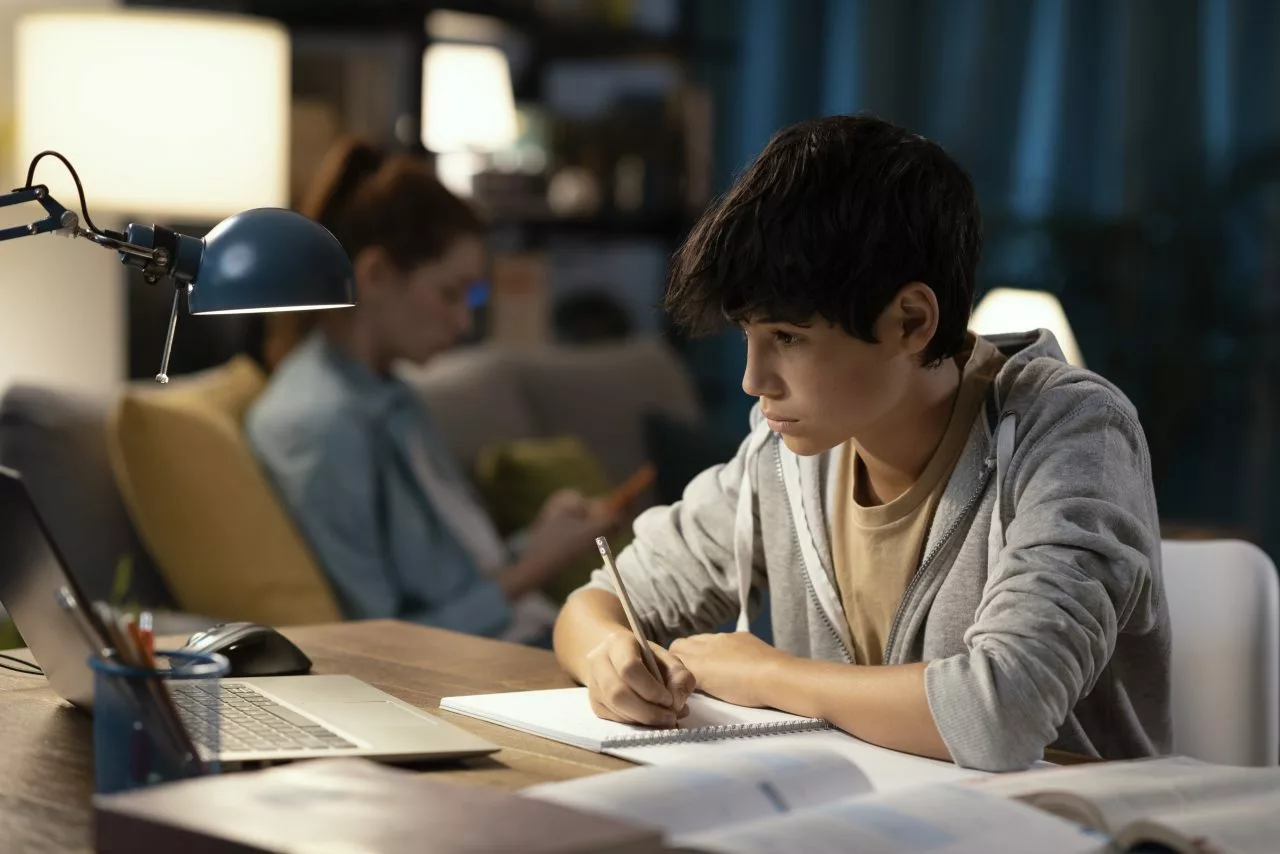 teenager-watching-online-classes-at-night-e1697192102632